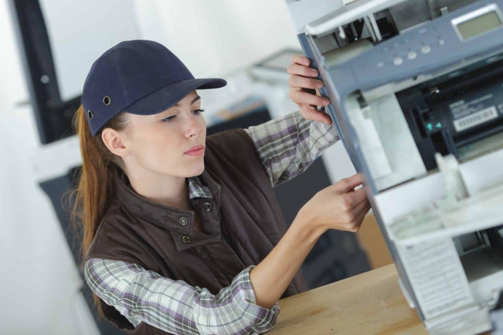 service my photocopy machine? woman servicing office photocopier